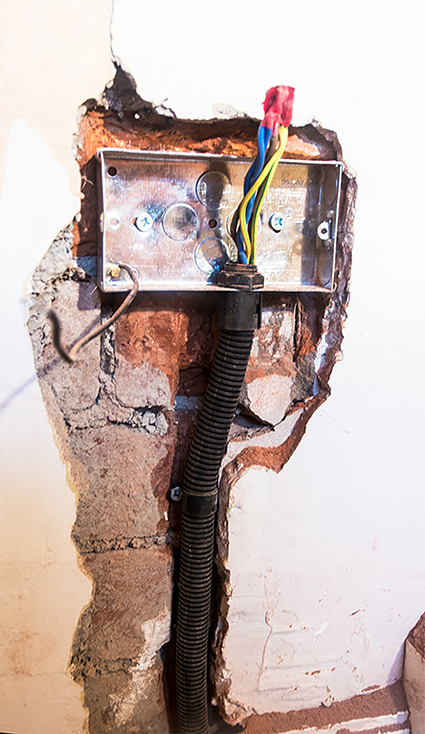 Socet and conduit in wall