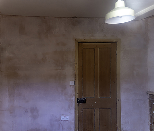 Plastered wall with door in middle
